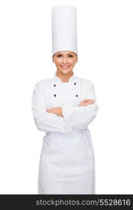 cooking and food concept - smiling female chef with crossed arms