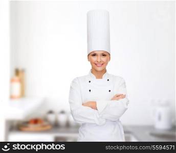 cooking and food concept - smiling female chef with crossed arms
