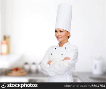 cooking and food concept - smiling female chef with crossed arms