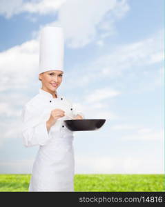 cooking and food concept - smiling female chef with pan and spoon