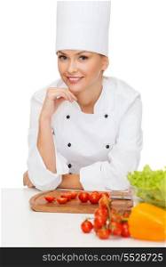 cooking and food concept - smiling female chef with vegetables