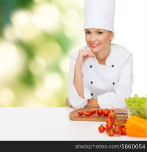 cooking and food concept - smiling female chef with vegetables