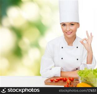 cooking and food concept - smiling female chef with vegetables showing ok sign