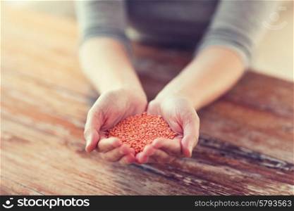 cooking and home concept - cloes up of female cupped hands with quinoa