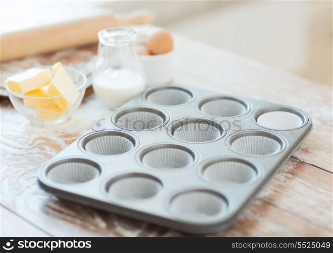 cooking and home concept - close up of empty muffins molds