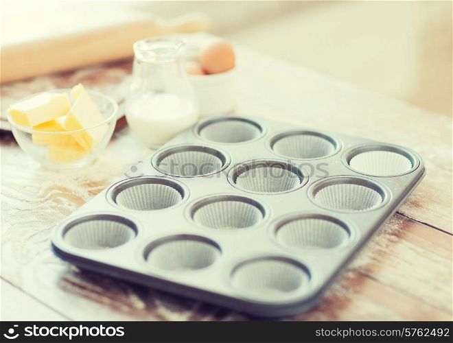 cooking and home concept - close up of empty muffins molds