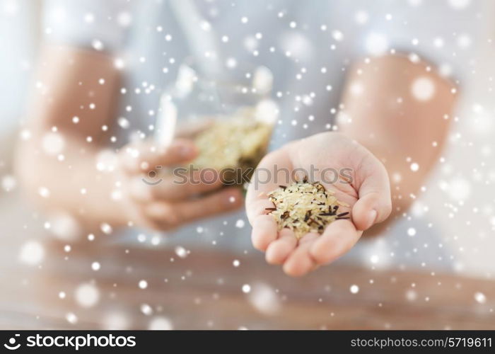 cooking and home concept - close up of female emptying jar with mixture of white and wild black rice