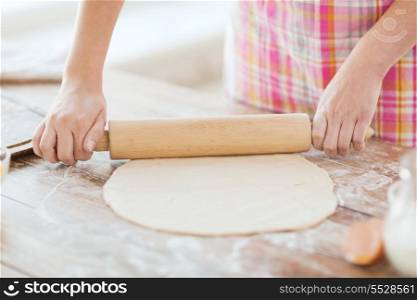 cooking and home concept - close up of female working with rolling-pin