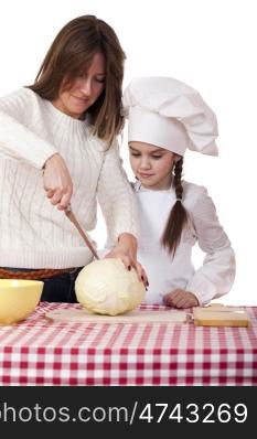 Cooking and people concept - Little girl in cook hat and mother, isolated on white background