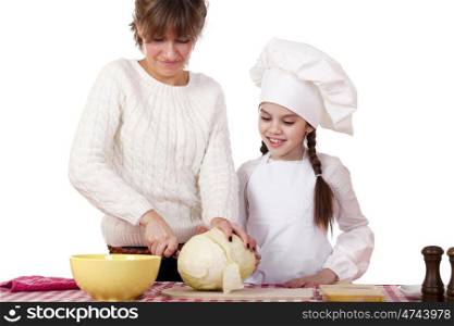 Cooking and people concept - Little girl in cook hat and mother, isolated on white background