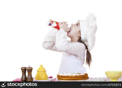 Cooking and people concept - smiling little girl in cook hat, isolated on white background