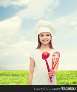 cooking and people concept - smiling little girl in cook hat with ladle and whisk