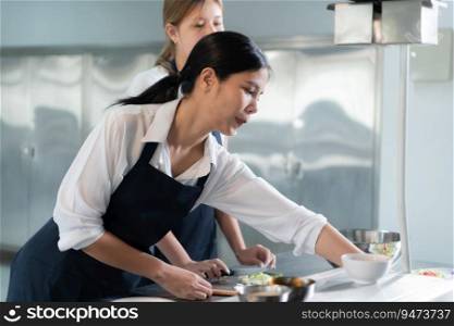 Cooking apprentices prepare meals and ingredients before the chef arrives to instruct at the culinary academy&rsquo;s kitchen.