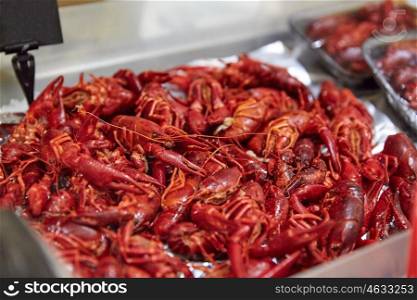 cooking, asian kitchen, sale and food concept - boiled red crayfish at street market