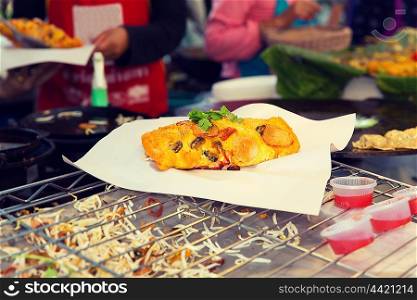 cooking, asian kitchen, sale and food concept - close up of snack at street market