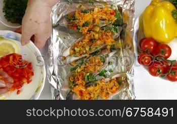 Cooking Baked Fish - Add vegetables and lemon slices. Shoot from above