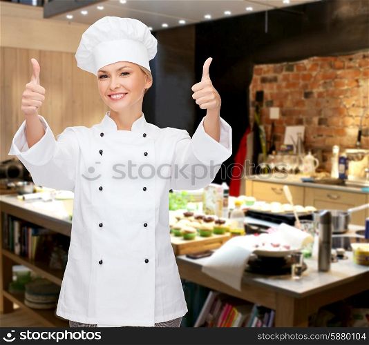 cooking, bakery, gesture and food concept - smiling female chef, cook or baker showing thumbs up over restaurant kitchen background