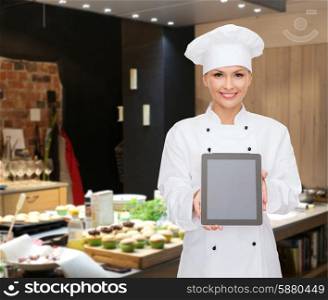 cooking, bakery, people, technology and food concept - smiling female chef, cook or baker showing tablet pc computer blank screen over restaurant kitchen background
