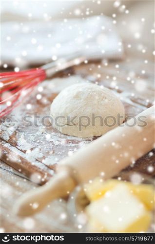 cooking, baking and home concept - close up of bread dough and utensils on cutting board
