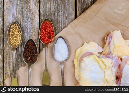 Cooking chicken. The table with the ingredients for the dishes. On a wood background. raw chicken meat with herbs and spices. Cooking chicken. The table with the ingredients for the dishes. wood background.