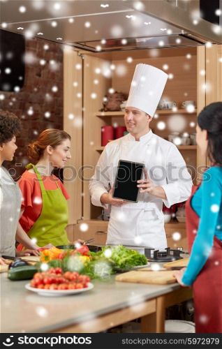 cooking class, culinary, food, technology and people concept - happy women with chef cook showing blank tablet pc screen in kitchen over snow effect