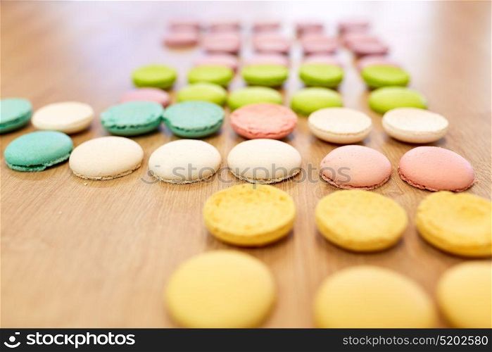 cooking, confectionery and baking concept - macarons on table. macarons on table at confectionery or bakery