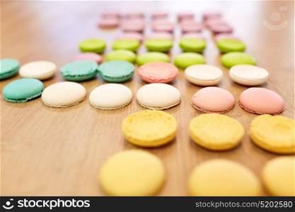 cooking, confectionery and baking concept - macarons on table. macarons on table at confectionery or bakery