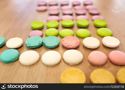 cooking, confectionery and baking concept - macarons on table. macarons on table at confectionery or bakery