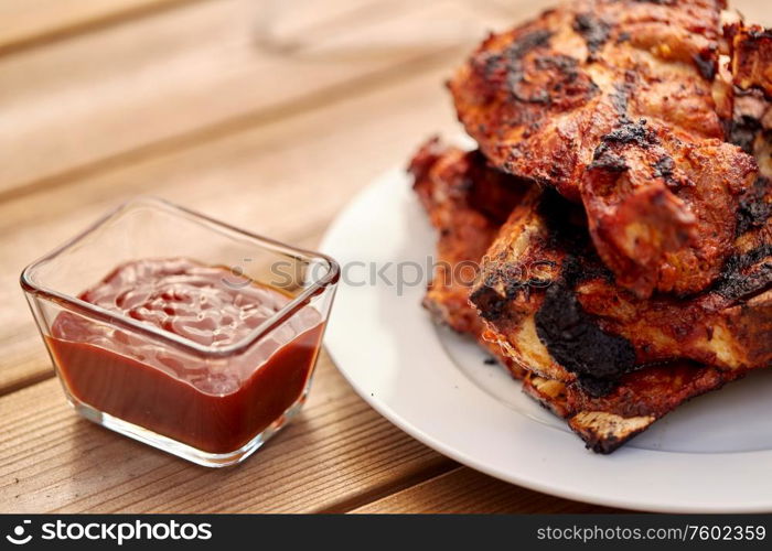 cooking, culinary and food concept - close up of grilled barbecue meat stack on plate. grilled barbecue meat stack on plate