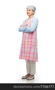 cooking, culinary and old people concept - portrait of smiling senior woman in kitchen apron with crossed arms over white background. portrait of smiling senior woman in apron