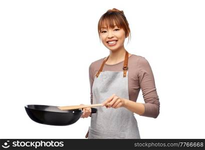 cooking, culinary and people concept - happy smiling female chef in apron with frying pan and spatula over white background. happy smiling female chef with frying pan