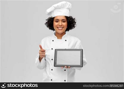 cooking, culinary and people concept - happy smiling female chef in toque and jacket with tablet pc computer over grey background. smiling female chef with tablet computer