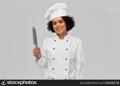 cooking, culinary and people concept - happy smiling female chef in white toque and jacket with kitchen knife over grey background. smiling female chef in toque with kitchen knife