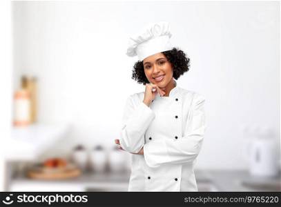 cooking, culinary and people concept - happy smiling female chef in white toque and jacket over restaurant kitchen background. smiling female chef in white toque in kitchen