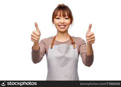 cooking, culinary and people concept - happy smiling female chef or waitress in apron showing thumbs up over white background. happy female chef or waitress showing thumbs up