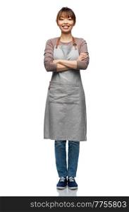 cooking, culinary and people concept - happy smiling woman in apron with crossed arms over white background. smiling woman in apron with crossed arms