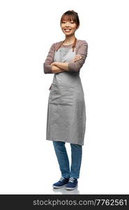 cooking, culinary and people concept - happy smiling woman in apron with crossed arms over white background. smiling woman in apron with crossed arms