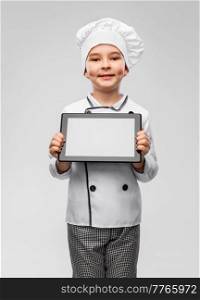 cooking, culinary and profession concept - happy smiling little boy in chef&rsquo;s toque and jacket holding tablet pc computer over grey background. smiling little boy in chef&rsquo;s toque with tablet pc