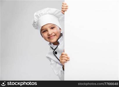 cooking, culinary and profession concept - happy smiling little girl in chef&rsquo;s toque and jacket with white board over grey background. happy little girl in chef&rsquo;s toque with white board