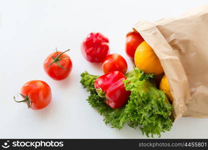 cooking, diet, vegetarian food and healthy eating concept - close up of paper bag with fresh ripe juicy vegetables and greens on kitchen table at home