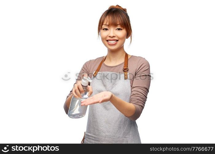 cooking, disinfection and health concept - happy smiling female chef or waitress in apron applying hand sanitizer or liquid soap over white background. happy woman in apron with hand sanitizer or soap