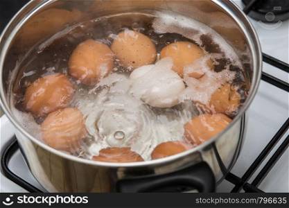 cooking Eggs in boiling water in pan Top view, healthy food. cooking Eggs in boiling water in pan Top view