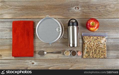 Cooking equipment for Hiking or camping organized on rustic wooden boards.