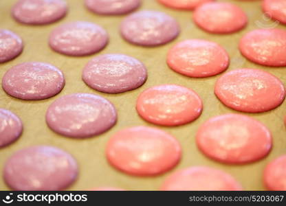 cooking, food and confectionery concept - macaron batter or meringue cream on baking paper at pastry shop. macaron batter or meringue cream on baking paper