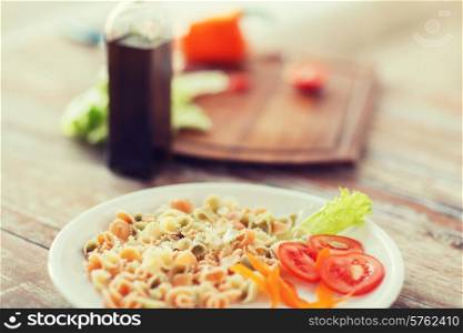cooking, food and home concept - close up of pasta meal on plate