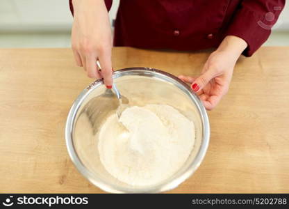 cooking food, baking and people concept - chef with flour in bowl making batter or dough. chef with flour in bowl making batter or dough