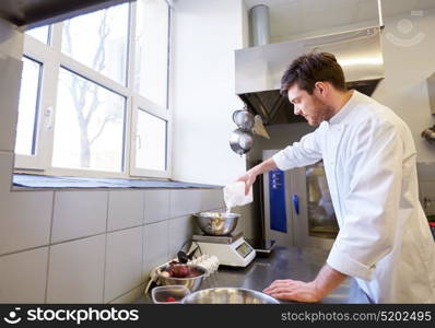 cooking food, baking and people concept - happy male chef cook with eggs pouring flour into bowl on scale at restaurant or bakery kitchen. happy male chef cooking food at restaurant kitchen