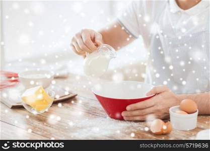 cooking, food, people and home concept - close up of man pouring milk to bowl