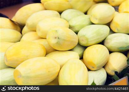 cooking, fruits, sale and food concept - peeled mango at street market