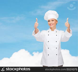 cooking, gesture and food concept - smiling female chef, cook or baker showing thumbs up